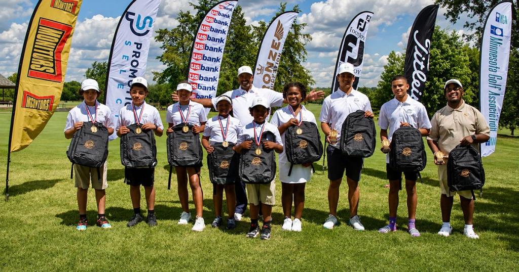 Bronze Foundation President Darwin Dean with youth golfers at Hiawatha Golf Course during the 2023 Upper Midwest Bronze Amateur Tournament.