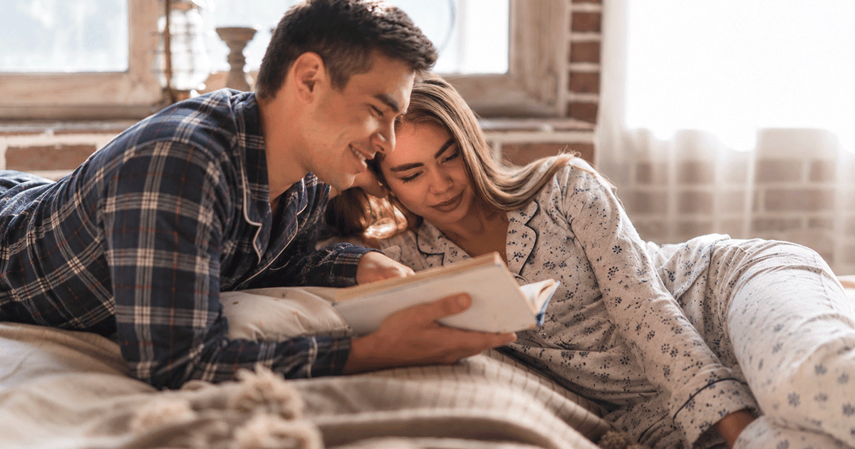 Couple relaxing together indoors during fall in Minneapolis, illustrating cuffing season, companionship and connection.